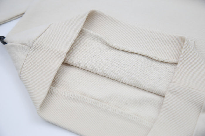 Kangaroo pocket and rib cuff detail on oat french terry kids hoodie
