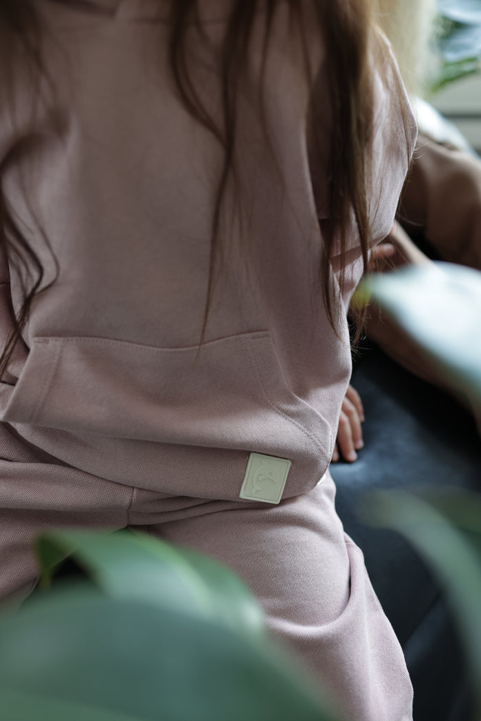 Close-up of brushed terry fabric and tapered fit – wheat kids sweatpants