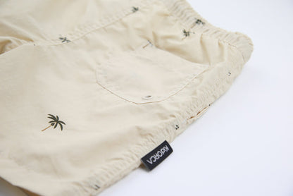 Close-up of quick-dry recycled nylon fabric – palm almond swim trunks
