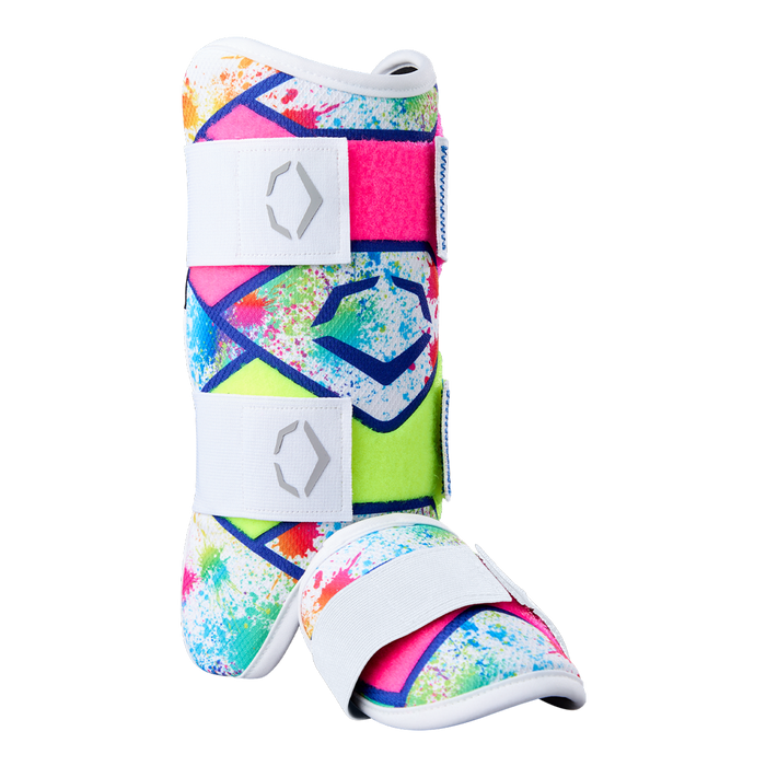 The EvoShield SRZ-2 Youth Batter's Leg Guard by EvoShield features a vibrant splatter pattern in pink, blue, green, and yellow with white adjustable straps and sole—engineered for comfort much like an ergonomic medical walking boot.