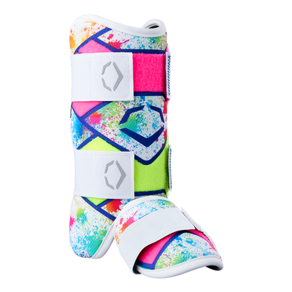 The EvoShield SRZ-2 Youth Batter's Leg Guard by EvoShield features a vibrant splatter pattern in pink, blue, green, and yellow with white adjustable straps and sole—engineered for comfort much like an ergonomic medical walking boot.