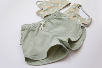 Close-up of quick-dry sage green fabric – girls swim trunks