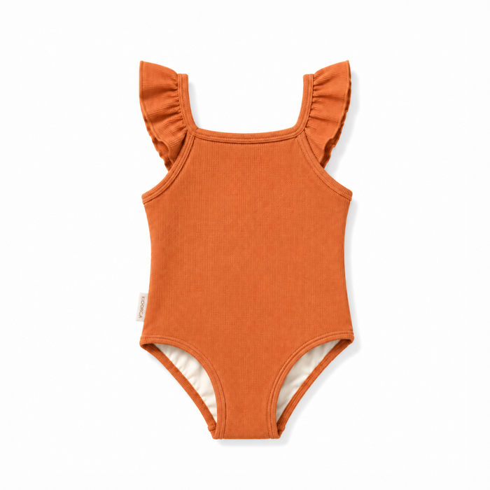 An orange ribbed baby bodysuit with ruffled shoulder straps and a white inner lining, shown flat on a white background.