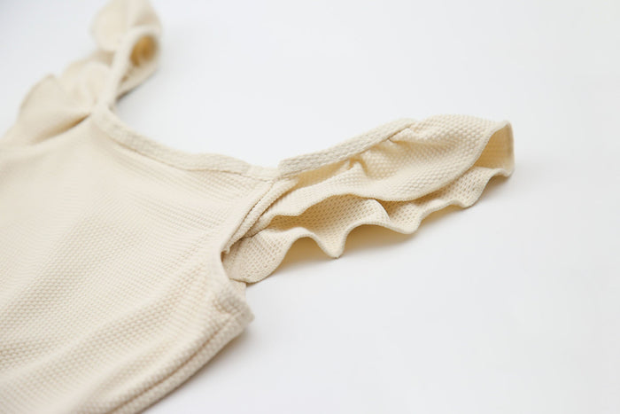 Close-up of waffle weave textured quick-dry fabric – almond variant swimsuit