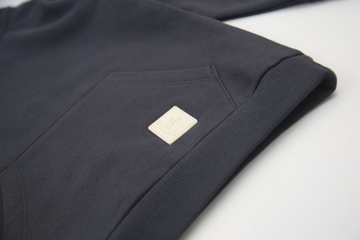 Kangaroo pocket and rib cuff detail on lava brushed terry kids hoodie
