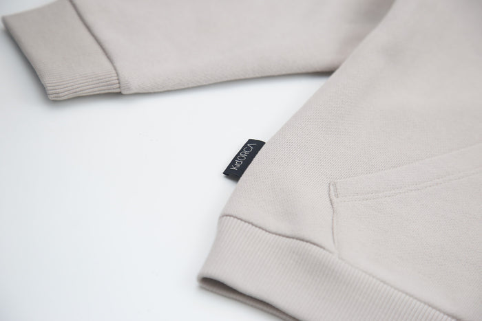 Kangaroo pocket and rib cuff detail on dove brushed terry kids hoodie