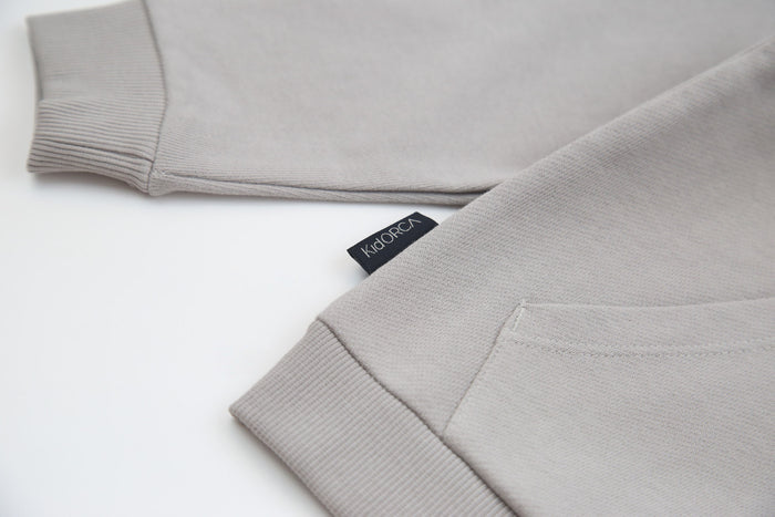 Kangaroo pocket and rib cuff detail on pebble french terry kids hoodie