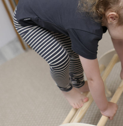 Kid playing in lava striped organic leggings by KidORCA