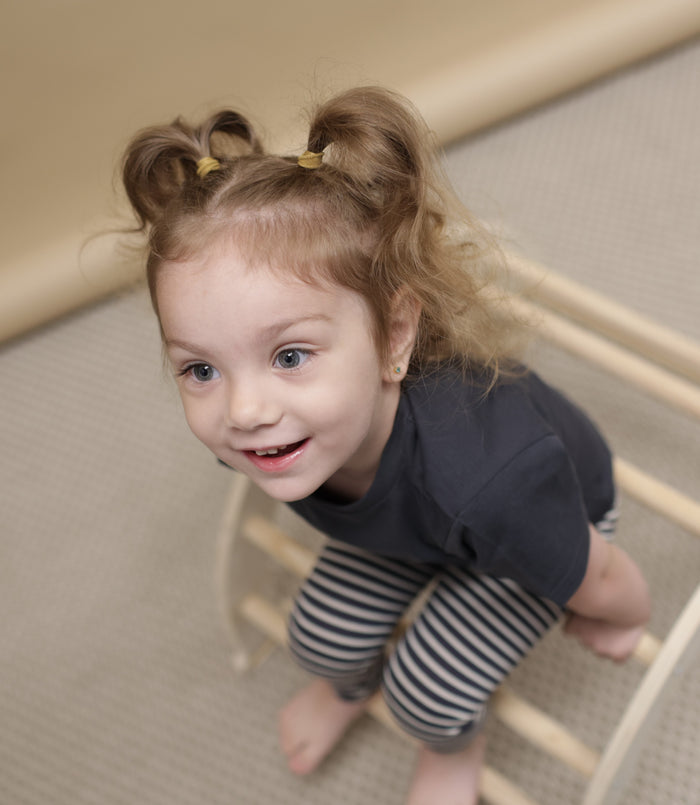 Kid playing in lava striped organic leggings by KidORCA