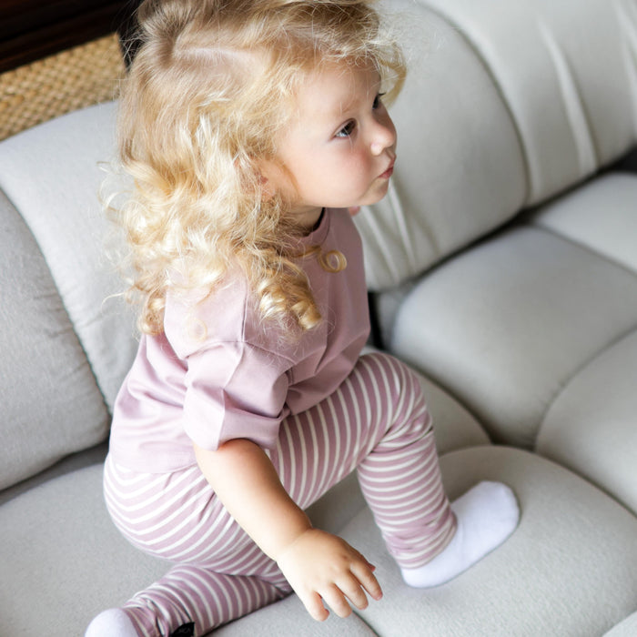 Kid playing in mauve striped extra‑long leggings by KidORCA