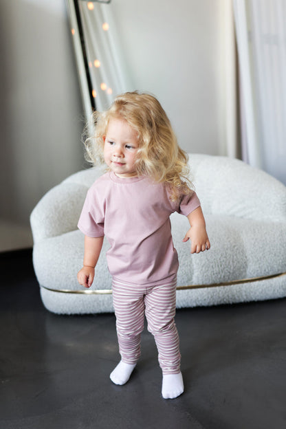 Kid playing in mauve striped extra‑long leggings by KidORCA