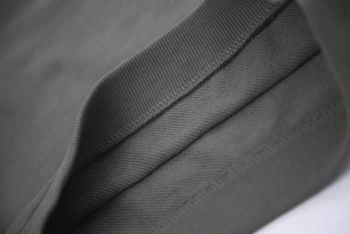 Hem and seam detail on dusty olive french terry kids shorts