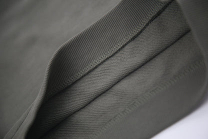 Hem and seam detail on dusty olive french terry kids shorts