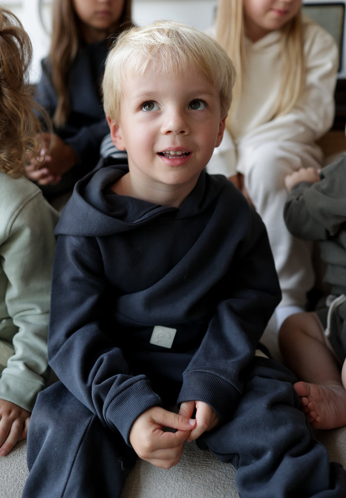 Child wearing lava brushed terry sweatpants – side view with elastic waist