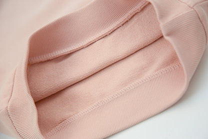 Close-up of organic french terry fabric texture – pale rose kids sweatpants