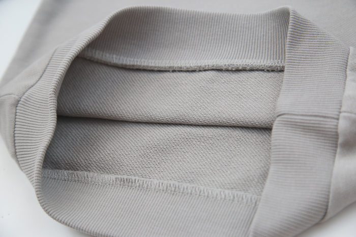 Close-up of organic french terry fabric texture – pebble grey kids sweatpants