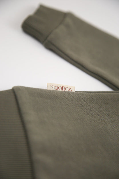 Rib cuff and hem detail on dusty olive french terry kids sweatshirt