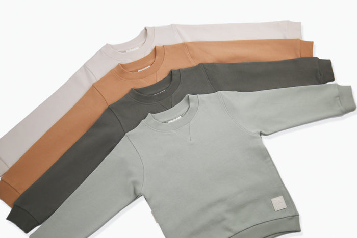 Close-up of french terry fabric and crewneck on oat kids sweatshirt