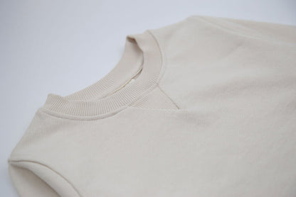 Close-up of french terry fabric and crewneck on oat kids sweatshirt