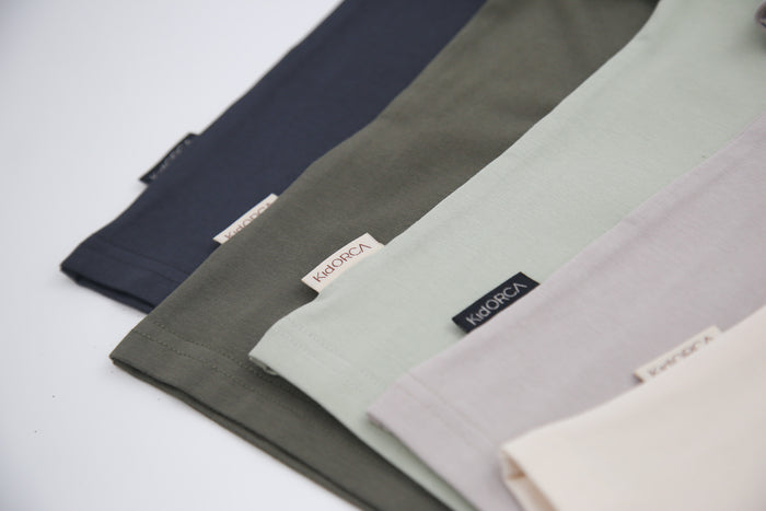 Seam and hem detail on dove grey kids tee