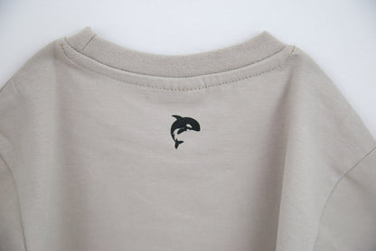Close-up of organic cotton fabric and crew neckline – dove kids tee