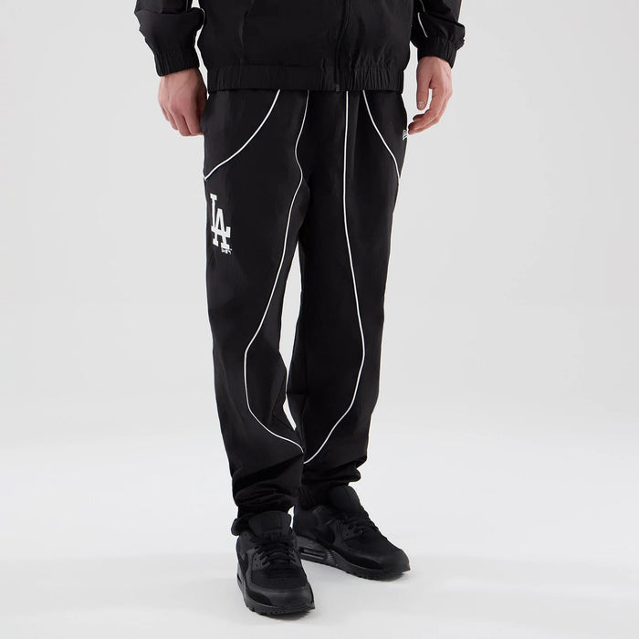 The model is wearing these MLB Piping Track LA Dodgers Track Pants in black. 3