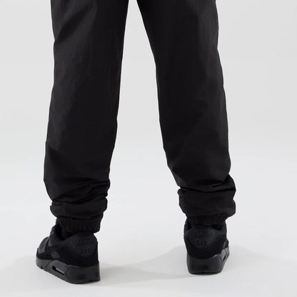 The model is wearing these MLB Piping Track LA Dodgers Track Pants in black. 4