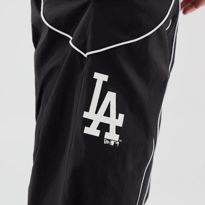 The model is wearing these MLB Piping Track LA Dodgers Track Pants in black. 5