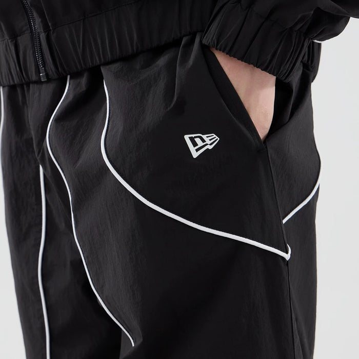 The model is wearing these MLB Piping Track LA Dodgers Track Pants in black. 6