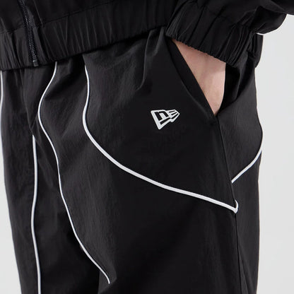 The model is wearing these MLB Piping Track LA Dodgers Track Pants in black. 6