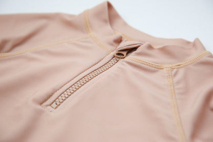 Girl wearing Tuscany rashguard – side view with long sleeves and zipper