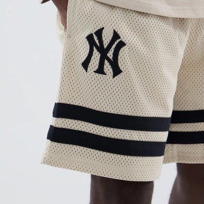 The model is wearing these MLB New York Yankees Oversized Mesh Shorts in light beige. 3