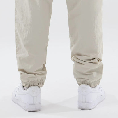 The model is wearing these MLB Piping Track New York Yankees Track Pants in cream. 7