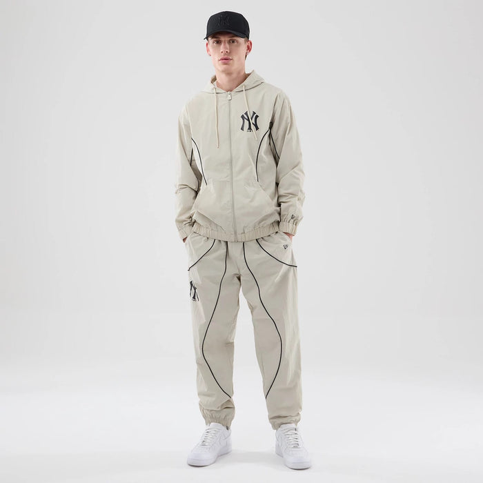 The model is wearing these MLB Piping Track New York Yankees Track Pants in cream. 8