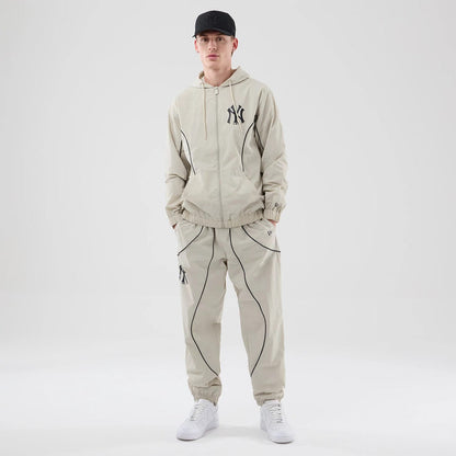 The model is wearing these MLB Piping Track New York Yankees Track Pants in cream. 8