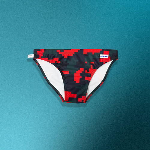 Black and red pixelated swim briefs on a teal background