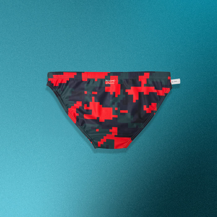 Pixelated red and black swim brief on a teal background