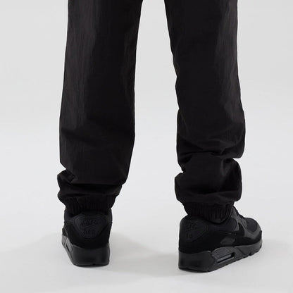 The model is wearing these Red Bull Racing Piping Track Pants in black. 3
