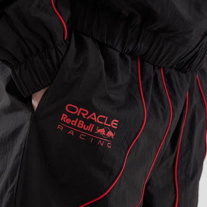The model is wearing these Red Bull Racing Piping Track Pants in black. 5