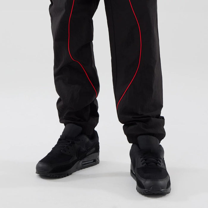 The model is wearing these Red Bull Racing Piping Track Pants in black. 7