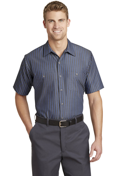 Male model wearing Red Kap Men's Short Sleeve Striped Industrial Work Shirt in gray with blue vertical stripes, featuring button-front closure and dual chest pockets.