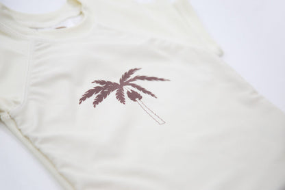 Close-up of UPF 50+ quick-dry recycled polyester – palm tree rashguard