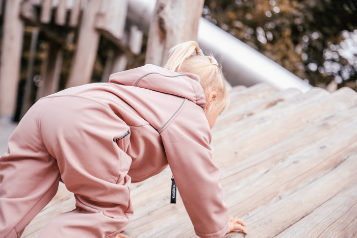 Child wearing ash-rose softshell overall by KidORCA