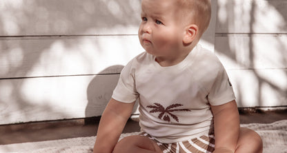 Kid playing in stripe khaki swim boardie shorts by KidORCA