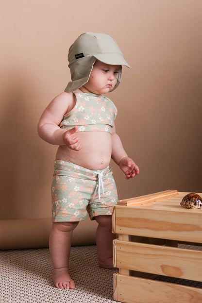 Girl playing in Evangelina sage swim top by KidORCA