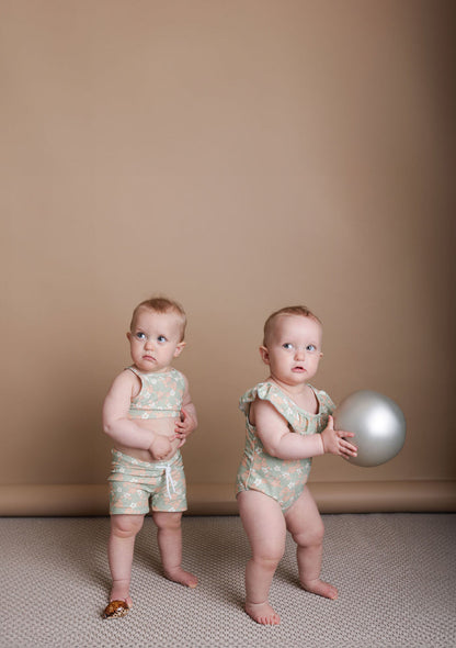 Girl playing in Evangelina sage swim top by KidORCA