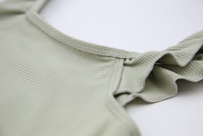Close-up of waffle weave textured quick-dry fabric – sage swimsuit